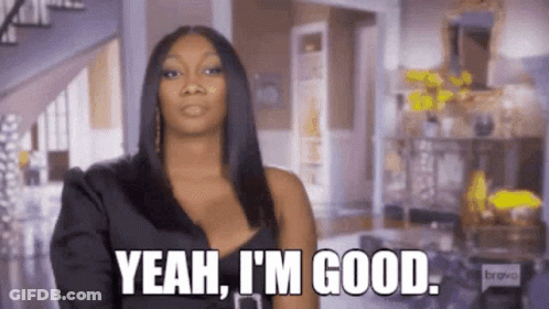 A Woman In A Black Dress Is Standing In A Living Room And Saying `` Yeah , I 'M Good '' . GIF