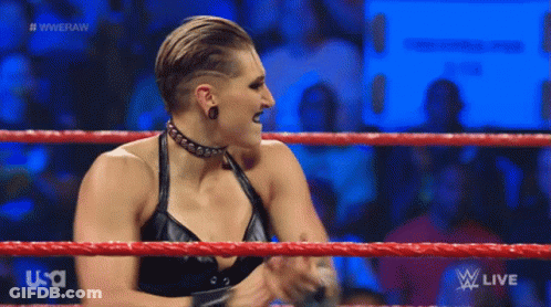 A Woman In A Black Dress Is Standing In A Wrestling Ring On Usa Network . GIF