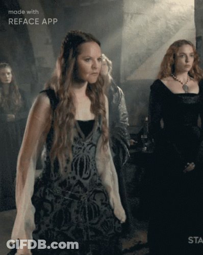A Woman In A Black Dress Is Standing In Front Of A Sign That Says " Made With Reface App " GIF