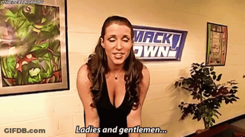 A Woman In A Black Dress Is Standing In Front Of A Wall With A Sign That Says `` Ladies And Gentlemen '' . GIF