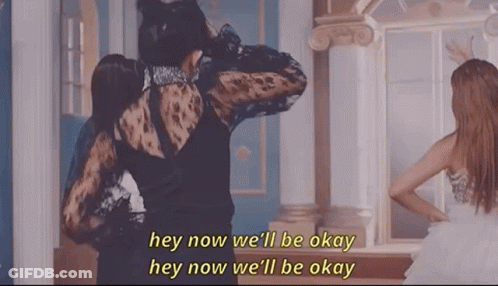 A Woman In A Black Dress Is Standing Next To Another Woman In A White Dress In Front Of A Mirror . GIF