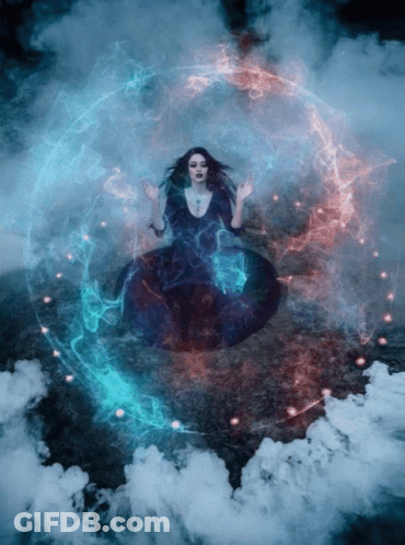A Woman In A Black Dress Is Surrounded By Smoke GIF