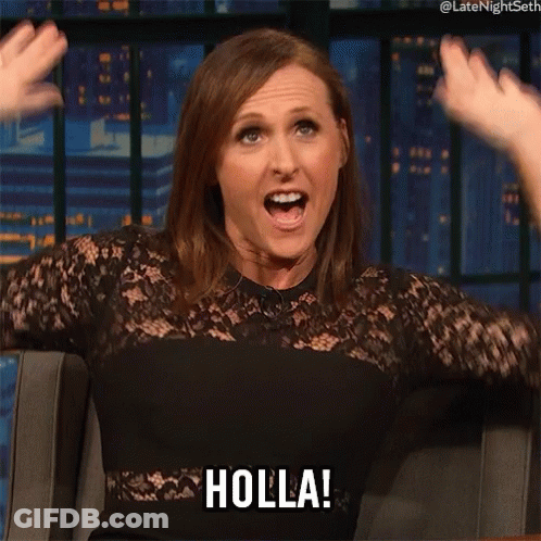 A Woman In A Black Dress Says Holla With Her Mouth Open GIF