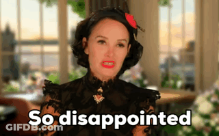 A Woman In A Black Dress Says So Disappointed In Front Of A Window GIF