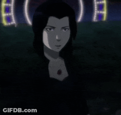 A Woman In A Black Dress Stands In Front Of A Sign That Says ' A ' GIF