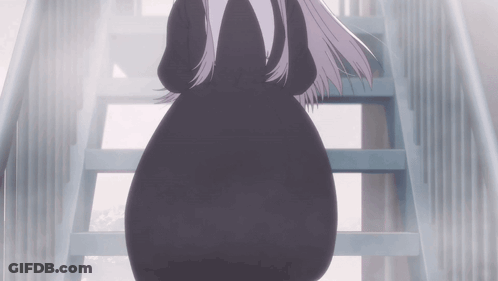 A Woman In A Black Dress Walking Down Stairs GIF