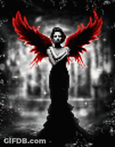 A Woman In A Black Dress With Red Wings Is Standing In The Dark GIF