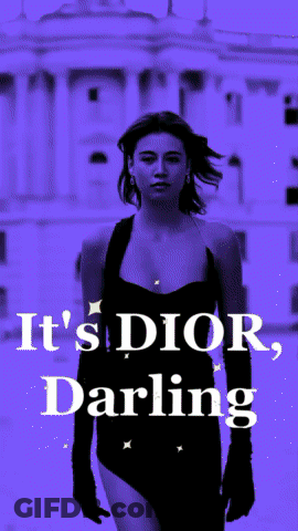 A Woman In A Black Dress With The Words It 'S Dior Darling On The Bottom GIF