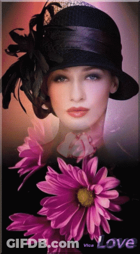 A Woman In A Black Hat Is Surrounded By Purple Flowers And The Word Love Is On The Bottom GIF