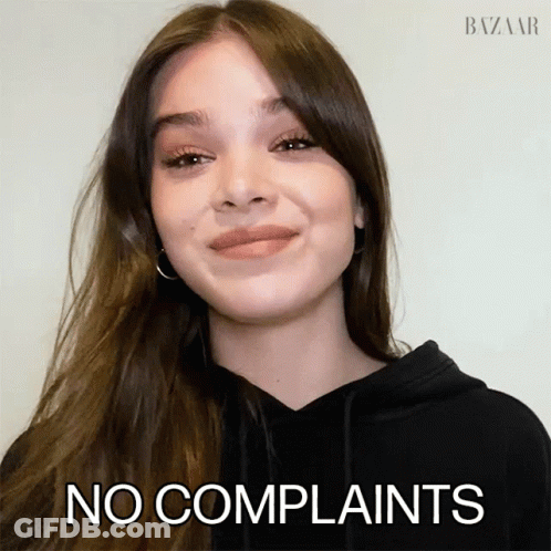A Woman In A Black Hoodie Says No Complaints In Front Of Her Face GIF