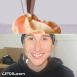 A Woman In A Black Hoodie Smiles In Front Of A Picture Of An Apple GIF