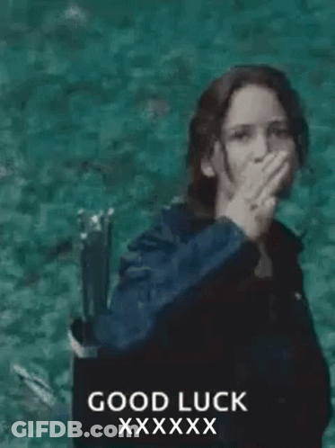 A Woman In A Black Jacket Is Giving The Middle Finger In Front Of The Ocean . GIF