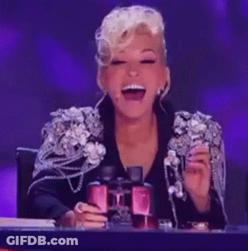 A Woman In A Black Jacket Is Laughing And Holding A Pair Of Binoculars GIF
