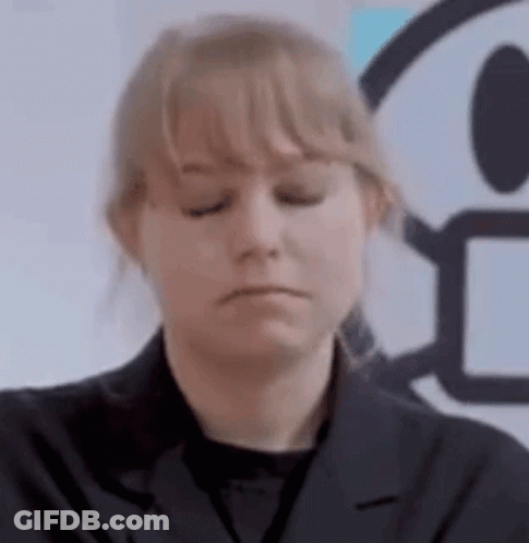 A Woman In A Black Jacket Is Making A Sad Face . GIF