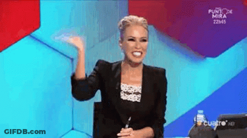 A Woman In A Black Jacket Is Sitting In Front Of A Blue And Red Background . GIF