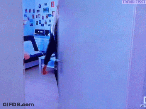 Woman In Black Jacket Standing In Doorway GIF