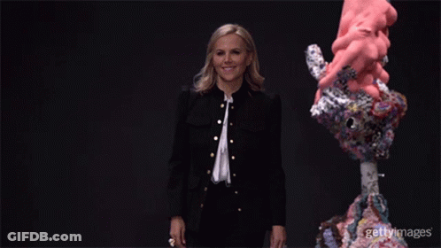 A Woman In A Black Jacket Is Standing In Front Of A Sculpture With The Words Gettyimages On The Bottom Right GIF