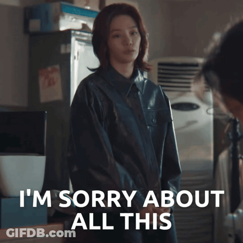 A Woman In A Black Jacket Says I 'M Sorry About All This In White Letters GIF