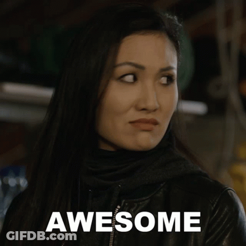 A Woman In A Black Jacket With The Word Awesome Written On It GIF
