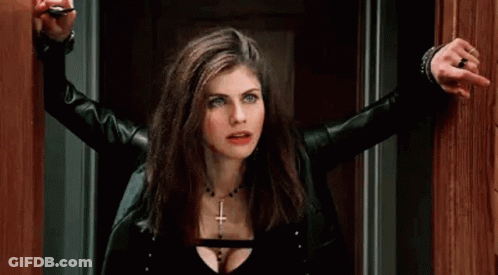 A Woman In A Black Leather Jacket Is Holding A Key In Her Hand . GIF