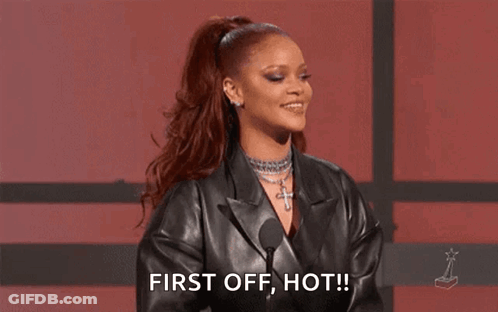 A Woman In A Black Leather Jacket Is Standing In Front Of A Microphone . GIF
