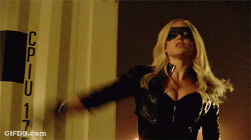 A Woman In A Black Mask Is Standing In Front Of A Sign That Says Cpiu 17 GIF