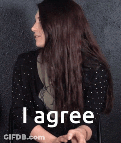 A Woman In A Black Polka Dot Shirt Says I Agree GIF