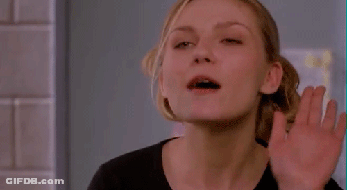 A Woman In A Black Shirt Is Making A Funny Face GIF