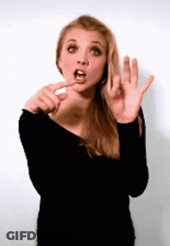 A Woman In A Black Shirt Is Making A Funny Face With Her Mouth Open GIF