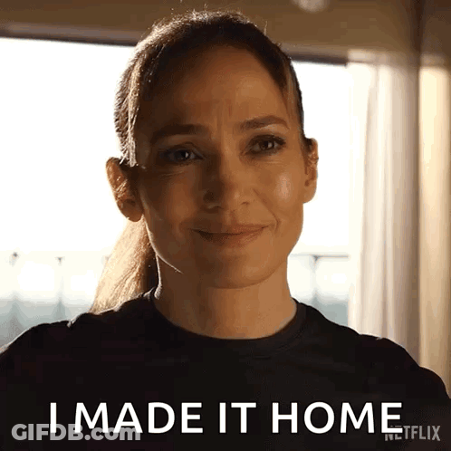 Woman In Black Shirt Smiling Saying I Made It Home GIF
