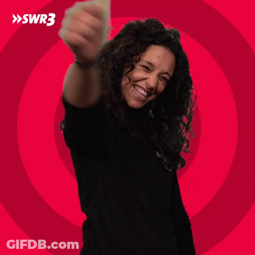A Woman In A Black Shirt Is Smiling In Front Of A Red Circle With Swr3 Written On It GIF