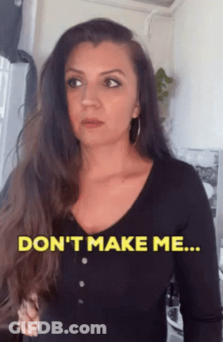 A Woman In A Black Shirt Says " Don 'T Make Me ... " GIF