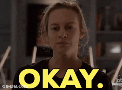 A Woman In A Black Shirt Says Okay GIF