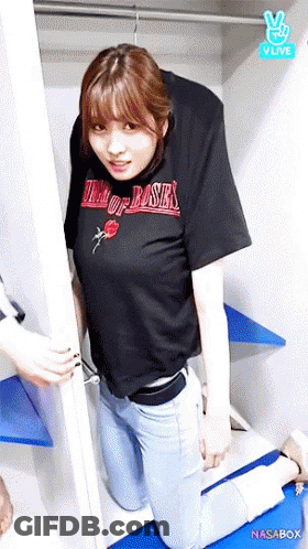 A Woman In A Black Shirt That Says King Of Roses GIF