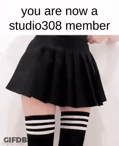A Woman In A Black Skirt And Striped Knee High Socks GIF