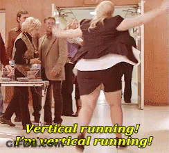 A Woman In A Black Skirt Is Running In Front Of A Group Of People With The Caption Vertical Running I 'M Vertical Runnin GIF
