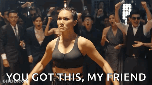 A Woman In A Black Sports Bra Stands In Front Of A Crowd And Says You Got This My Friend GIF