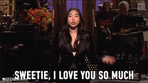 A Woman In A Black Suit Says Sweetie I Love You So Much In Front Of A Band GIF