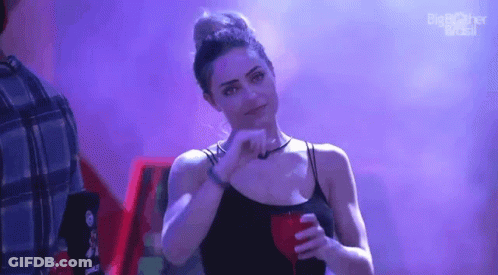 Woman In Black Tank Top Making Face With Red Drink GIF