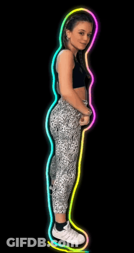 A Woman In A Black Top And Leopard Print Leggings Dancing GIF