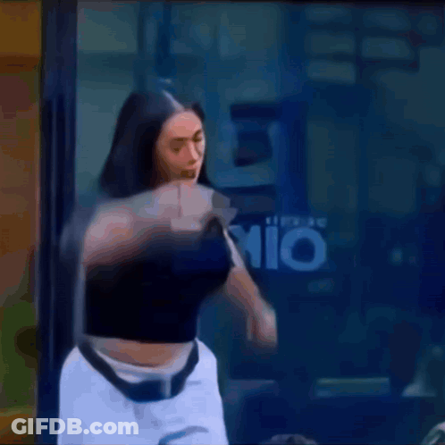 A Woman In A Black Top And White Shorts Is Standing In Front Of A Window With The Letter P On It .. GIF