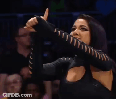 A Woman In A Black Top Is Giving A Thumbs Up Sign . GIF