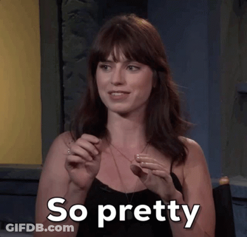 A Woman In A Black Top Says So Pretty In White Letters GIF