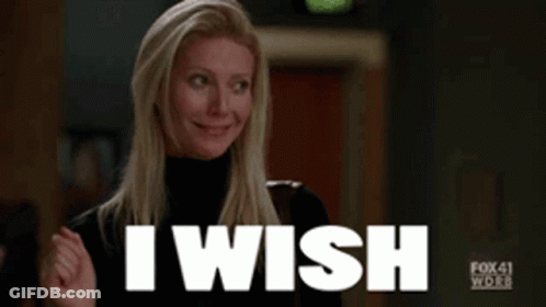 A Woman In A Black Turtleneck Is Smiling And Saying I Wish GIF
