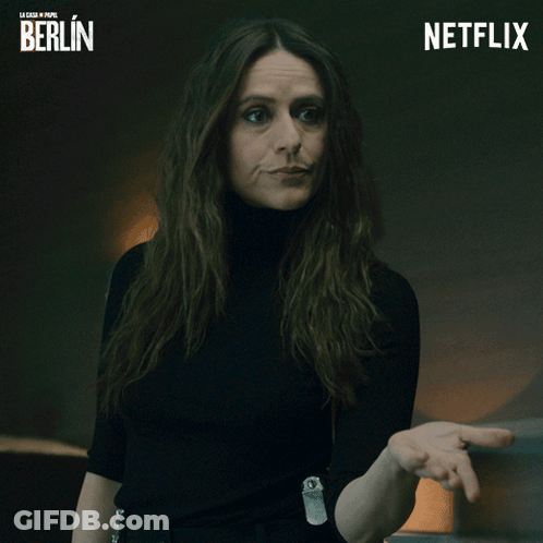 Woman In Black Turtleneck Next To Netflix Logo GIF