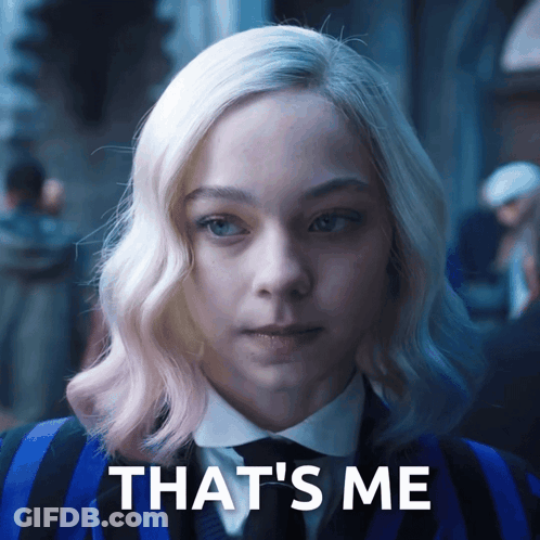 A Woman In A Blue And Black Suit With The Words That 'S Me On The Bottom GIF