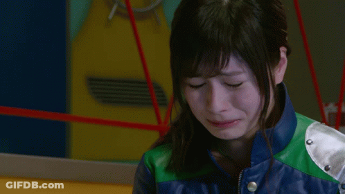 A Woman In A Blue And Green Leather Jacket Is Crying GIF