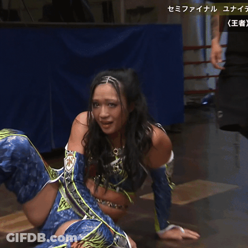 A Woman In A Blue And Purple Outfit Is Crying With Chinese Writing Behind Her GIF