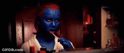 A Woman In A Blue And Red Costume Is Brushing Her Teeth In Front Of A Mirror . GIF