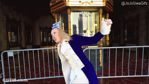 A Woman In A Blue And White Costume Is Standing In Front Of A Fence With The Number 6030 On It GIF